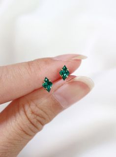 Tiny diamond shaped stud earrings in a rich vibrant emerald green - an everyday staple for the modern minimalist.  Hand set faceted vintage Swarovski crystals.  Hardware has been tumble polished for hours to achieve a satin finish, butterfly backings.  Packaged in a beautiful gift box.Perfect for standard lobe piercings and small enough to be great stacking pieces for 2nd and 3rd piercings.MATERIALS[ stone ] genuine Swarovski crystal[ silver ] rhodium silver filled, sterling silver posts[ gold ] Dainty May Birthstone Earrings, Everyday Minimalist Emerald Jewelry, Minimalist 14k Gold May Birthstone Earrings, Emerald Earrings For Everyday May Birthstone, Emerald Earrings For Everyday And May Birthstone, Minimalist Green Earrings For Anniversary, Green Minimalist Earrings For Anniversary, Minimalist May Birthstone Earrings, Minimalist Green Hypoallergenic Jewelry