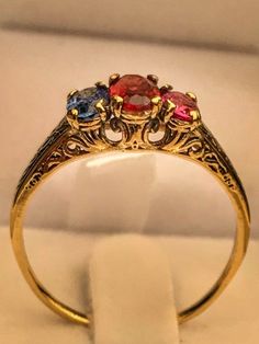 "Very unique handmade gold ring with real gamstones . 14k gold antique victorian ring with a real garnet stones in the middele + 1 real beautiful ruby in the side + one real beautiful sapphire on the other side . Hand made by myself Weight : about 1.9 gram Central stone : garnet 4/6 m\"m Ruby stone : 3/5 mm Sapphire stone : 3/5 mm" Yellow Gold Multi-stone Ruby Ring, Vintage Oval Sapphire Birthstone Ring, Unique Multi-stone Ruby Ring In Yellow Gold, Multi-stone Ruby Ring In Yellow Gold, Vintage Oval Sapphire Ring As Birthstone, Elegant Yellow Gold Ruby Ring With Intricate Design, Antique Multi-stone Yellow Gold Jewelry, Antique Yellow Gold Multi-stone Jewelry, Red Multi-stone Sapphire Ring