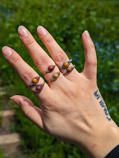 Handmade Adjustable Wire Wrapped Gemstone Rings/ Beaded Rings/ Gemstone Ring/ Birthsone Jewelry/ Unique Jewelry/ Stackable Rings 🖤✨Choose a band that's adornably you. Just pick a metal type and enter your ring size and I'll size them to fit just right! Plus, They are adjustable so don't worry if you don't know your exact size✨ 🖤  Due to the natural variations in gemstones , the colors of each stone may differ slightly from what is pictured. It's a feature not a flaw 💗 🤘METAL INFO BRASS Brass jewelry is budget-friendly and built to last. Made from copper and zinc, it gives a warm gold shine without the price tag of real gold. Brass is resistant to corrosion and rust. It's tougher than silver and won't wear off like plated metals. Over time, Brass will develop a unique vintage patina, ma Adjustable Bohemian Rings With Stones, Bohemian Adjustable Rings With Stones, Adjustable Brown Ring Jewelry, Adjustable Bohemian Beaded Rings, Adjustable Stackable Brown Jewelry, Adjustable Brown Stackable Jewelry, Adjustable Brown Gemstone Rings, Brown Natural Stone Ring, Brown Natural Stone Rings