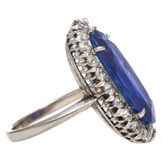 Shop this antique relic from a simpler time. An unheated 11.30-carat oval cut Blue Sapphire of Burmese origin. Set in platinum with a round-cut diamond halo. GRS certified with origin report. Circa late 1800's. The sapphire's natural inclusions, akin to distinctive birthmarks, give the stone a genuine authenticity and individuality, adding a unique personality and character.  This ring features a long oval cut that sits beautifully on the finger. Designed with an open back setting that maximizes Antique Blue Oval Diamond Ring, Antique Blue Diamond Ring For Formal Occasions, Antique Oval Sapphire Diamond Ring, Victorian Sapphire Ring With Diamond Oval Shape, Victorian Oval Sapphire Ring With Diamond, Antique Oval Sapphire Ring With Diamond Accents, Victorian Oval Sapphire Ring With Center Stone, Victorian Sapphire Oval Rings, Victorian Oval Sapphire Ring