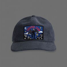 a blue hat with an image of a batman on the front and stars in the back