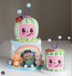 there are two cakes decorated with cartoon characters on the top one has a rainbow, and the other has a ladybug