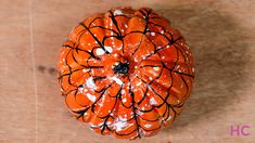 an orange painted pumpkin sitting on top of a wooden table