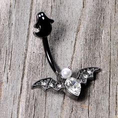 Clear Gem Black Ghost Vampire Bat Halloween Double Mount Belly Ring Start your Halloween shopping with a little treat for yourself with this 14 gauge navel jewelry with tons of holiday spirit. Made with a 3/8" black PVD over 316L surgical grade stainless steel curved barbell, this navel piercing features a black ghost top charm and a vampire bat bottom charm set with clear gems and a white orb for very spooky style.Specifications14 Gauge (1.6mm), 3/8" (10mm), Black PVD over 316L Surgical Grade S Black Piercings For Halloween Gift, Gothic Piercings For Halloween Gift, Silver Body Jewelry For Halloween, Halloween Silver Body Jewelry Gift, Black Ghost, Jewelry Promotion, Spooky Style, Bat Halloween, Navel Jewelry