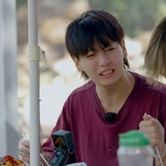 two people sitting at a table eating food