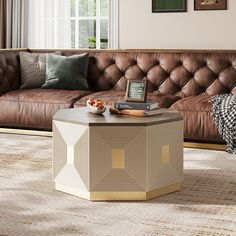 a living room with a couch, coffee table and pictures on the wall