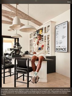 a woman sitting on top of a counter next to a bar