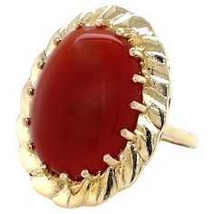 At just over fourteen carats this impressive Carnelian Cabochon Cocktail Ring is a real stand out. Set in bright 14 karat yellow gold, this 1950s cocktail ring sits high in its gallery with an interesting crimped wide gold bezel which frames the prong set warm-toned 15mm x 20mm oval Carnelian stone. From the Chalcedony family, Carnelian is sometimes known as "the stone of the sun". Sure to get noticed for its rich color and size, this attractive ring is in a generous ring size 8 and can be resized. Gift wrapped. Antique Cocktail Ring, Yellow Gold Cocktail Ring, Vintage Cocktail Ring, Gold Cocktail Ring, Peridot Stone, Carnelian Stone, Gold Cocktail, Antique Diamond, Blue Chalcedony