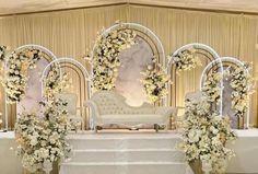 a white wedding set up with flowers and chairs