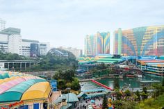 an amusement park with lots of rides and water slides in the middle of it, surrounded by tall buildings