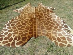 a giraffe skin is laying on the grass