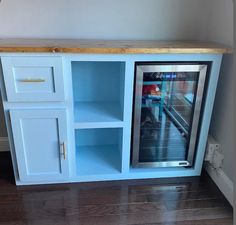 a refrigerator freezer sitting inside of a blue cabinet