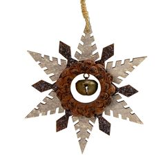 a metal snowflake with a bell hanging from it's center and an ornament in the middle