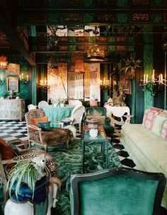 an ornately decorated living room with green walls and flooring is seen in this image