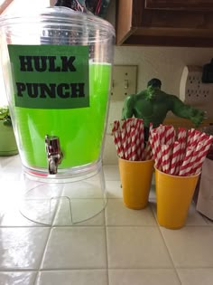 there are two cups with green drinks in them on the kitchen counter next to hulk punch