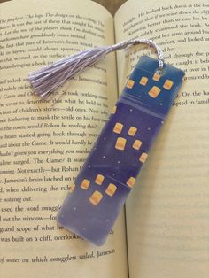 an open book with a tassel hanging from it