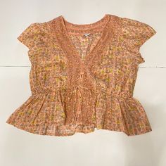 American Eagle Floral Blouse Size: Large Orange/Peach Color Cinched Waist 100% Cotton Condition: Good Summer Peach V-neck Blouse, Peach V-neck Summer Blouse, Peach Floral Print Summer Blouse, Peach Short Sleeve Summer Blouse, Peach Short Sleeve Top For Brunch, Peach Short Sleeve Blouse For Summer, Feminine Peach Tops For Spring, Feminine Peach Top For Spring, Pink Flowy Short Sleeve Top