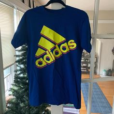 Adidas Blue T-Shirt W/Day Glo Font Size M Never Worn W/Tag Smoke/Pet Free Home In Mint/Excellent/Flawless Condition Wrinkles Will Be Ironed Out On Tumble Dry Blue Adidas T-shirt With Logo, Blue Sporty Adidas Logo T-shirt, Sporty Blue Adidas Logo T-shirt, Sporty Adidas Blue T-shirt, Blue Adidas Logo Sports Top, Blue Adidas Logo Top For Sports, Blue Sports T-shirt With Text Print, Sports Shirt With Blue Logo Print, Blue Adidas Logo Cotton Top