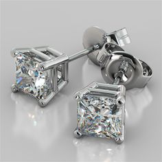 Elegant and refined, these princess cut stud earrings add an exceptional and glamorous look to your bride-to-be. Fashioned with an elegant 4-prong basket, each earring showcases a stunning princess-cut simulated diamonds that radiates unparalleled beauty. A look she will treasure forever.  Exquisitely made in 14K White Gold, this exceptional matched pair of stud earrings come with secured back posts for maximum comfort. Stone Size: 1.0CT Each Earring Stone Clarity: VS-1 Available in 14K White Go Silver Princess Cut Diamond Earrings, Elegant Princess Cut Earrings With Prong Setting, Elegant Princess Cut Diamond Earrings With Prong Setting, Princess Cut Earrings, Princess Cut Stud Earrings, Beautiful Diamond Earrings, Diamond Solitaire Earrings, Black Gold Jewelry, Stud Earrings For Men