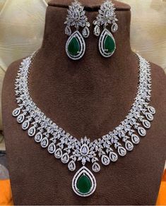 This absolutely stunning and elegant necklace set comes with dark green and white cubic zirconia encrusted stones on a silver base. This set come with necklace and earrings. Absolutely beautiful snd a must have. Would make a lovely anniversary or valentines gift.  This eye catching unique ethnic jewellery set is ideal for any traditional attire  Wear this with a saree , party wear on any festival or special occasions. This piece is readily available for immediate dispatch. Please note as this is Elegant Hand Set Emerald Diamond Necklace, Elegant Hand-set Emerald Diamond Necklace, Silver Luxury Emerald Necklace With Brilliant Cut, Exquisite Green Diamond Necklace, Dazzling Green Diamond Necklaces, White Gold Emerald Diamond Necklace For Wedding, Dazzling Green Diamond Necklace, Elegant Green Diamond Necklace Hand Set, Elegant Green Hand Set Diamond Necklace