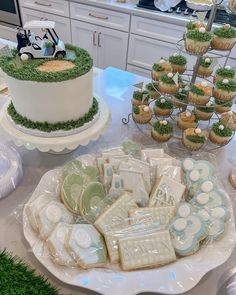 a table topped with lots of cakes and cupcakes