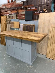 a kitchen island made out of pallets in a shop with other wood products on display