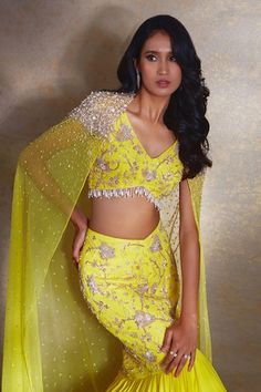 Yellow cape in a sheer base with bead gradient embroidery. Comes with mermaid skirt featuring embroidered floral jaal patterns highlighted by beads, pearls and ruffle tiered hemline. Paired with pearl and bead tasselled embroidered blouse. - Aza Fashions Fitted Lehenga With Cape Sleeves, Beads Tassels, Fishtail Skirt, Winter Sun, Embellished Blouse, Mermaid Skirt, Beaded Tassels, Embroidered Blouse, 8 Weeks