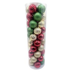 a vase filled with assorted christmas ornaments