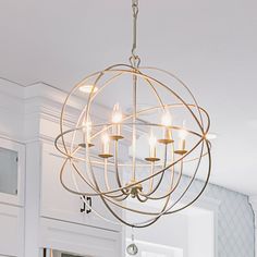 a chandelier hanging from the ceiling in a kitchen