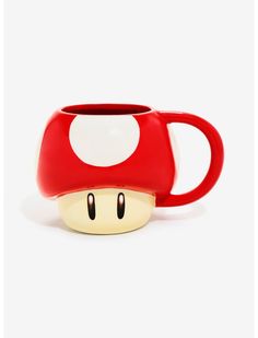 a red and white coffee cup with a mushroom on the inside, sitting in front of a white background