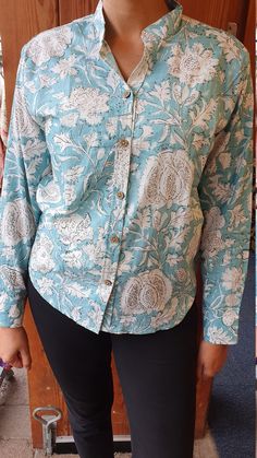 Made from 100 percent cotton, these beautifully coloured floral print shirts are perfect to wear over a pair of formal trousers or over jeans. You can turn these versatile shirts from office wear to evening/day wear by folding the sleeves and knotting up the ends. The sleeves also comes with two buttons to fit the wrist perfectly. This blouse is available in sizes 10-18 - please message to check availability before placing your order. The model is 5ft8in and wearing a size 12. Please note: The photograph is taken in natural light with the aim to capture the colour closest to the original, however it may differ slightly. Wash instructions: In cold water with mild detergent ** Please message to check size availability** Elegant Fitted Blouse With Printed Motifs, Collared Cotton Shirt With Floral Print, Printed Cotton Shirt For Work, Cotton Workwear Tops With Stand Collar, Long Sleeve Printed Cotton Blouse, Printed Long Sleeve Cotton Blouse, Fitted Cotton Shirt With Floral Print, Relaxed Fit Cotton Blouse With Stand Collar, Cotton Blouse With Relaxed Fit And Stand Collar