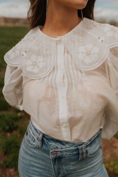 This is what I like to call... A beautiful blouse! 90% tencel Feminine and chic design Scalloped collar Working buttons Half puff sleeve Model is 5'7" and wearing a size small. Small: 2-4 Medium: 6-8 Large: 10-12 White Collared Blouse For Fall, Spring Blouse With Peter Pan Collar And Buttons, Spring Workwear Blouse With Detachable Collar, Spring Blouse With Detachable Collar For Daywear, White Blouse With Embellished Collar For Work, White Spring Blouse With Collared Neckline, Chic White Top With Embellished Collar, White Collared Blouse For Spring, Chic Tops With Embellished Collar For Work