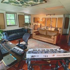 a living room filled with furniture and musical equipment