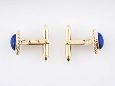 Modern Cufflinks Cabochon Cut Lapis in 18k Yellow Gold $2,550.00 These Modern cufflinks are made with lapis lazuli and 18k yellow gold. The lapis pieces are smooth, oval cabochons that are bordered by a frame of twisted gold wire. The buttery yellow gold provides a striking contrast to the vibrant blue of the gemstones. Composition: 18 Karat Yellow Gold, 14 Karat Yellow Gold INV: 4061 Primary Stone: Natural Lapis Lazuli Shape and Measurements: 7.5 mm x 3.5 mm (10) General Characteristics: Height Formal Lapis Lazuli Jewelry, Formal Yellow Gold Jewelry With Lapis Lazuli, Formal Yellow Gold Lapis Lazuli Jewelry, Antique Wedding Bands, Lapis Jewelry, Lapis Lazuli Jewelry, Gold Cufflinks, Jewelry Tags, Metal Shop