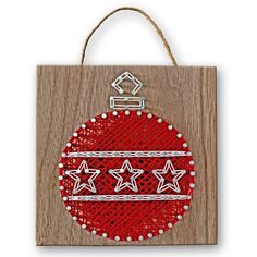 a christmas ornament hanging on a wooden plaque with string and beadwork