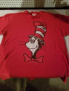 "Rare vintage find in red! Very nice image of the iconic cartoon character on a well looked after shirt, no issues. Blank back, one-sided print. Clean Seuss tags, size XL, about 21\" across armpits and 27\" front collar to hem. We ship worldwide and combine s & h for multiple purchases." Dr Seuss Shirt, Cat In The Hat, Dr Seuss, Stylish Shirts, Fashion Games, Tank Shirt, Tank Top Shirt, Cotton Shirt, Breathable Fabric