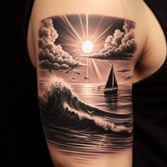 a man's arm with a sailboat in the ocean and birds flying over it