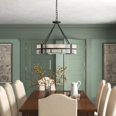 a dining room table with white chairs and a chandelier hanging from the ceiling