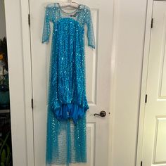 a blue dress hanging on a white door