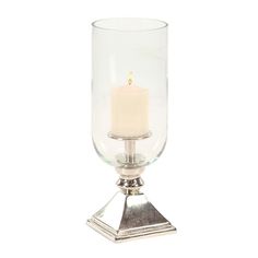 a small glass candle holder on a metal stand