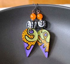 Funky Pop Art earrings featuring hand painted plexiglass components. The wildly colorful design of orange, green and purple reminds me somewhat of Keith Herrings work. They are paired with African powder glass beads and accented with silver plated spacers and bright orange quartz beads. These super light weight earrings measure approx. 3 inches dangling on niobium earring hooks. All pieces come boxed ready for gift giving or keeping for yourself.  Return to shop: bstrung.etsy.com More links wher Funky Pop Art, Funky Pop, Orange Green Purple, Abstract Earrings, Lampwork Earring, Earrings Teardrop, Pinterest Party, Painted Earrings, Art Earrings