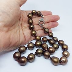 "For those who love richly colored earth-tone jewels, here is a rarity!  Tahitian \"Chocolate\" pearls are made from black Tahitian cultured pearls using a proprietary treatment (bleaching?) process which is not dye- it's permanent and does not change the luster and overtones of the original pearls.     This 18\" strand features an  oversized 14mm sterling silver lobster catch with pave' rose-cut diamonds on both sides, and a subtle black rhodium finish.  It can be used to hang a pendant as a ce Chocolate Pearls, Baroque Pearl Necklace, Sapphire Pendant, Black Rhodium, Choker Necklaces, Rose Cut Diamond, Baroque Pearls, Cultured Pearls, Rose Cut