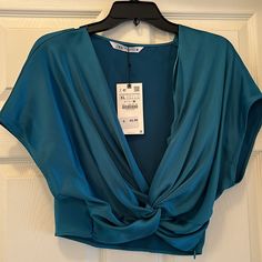 Nwt Zara Top Cropped Satin Material In A Beautiful Jewel Tone Turquoise. Marked Xl But Fits More Like M/L. Measures Dolman Sleeve Pro 20 And Length Is 18 With Size Hidden Zipper Closure. Clean And Smoke-Free Home Chic Turquoise Tops, Chic Blue Short Sleeve Crop Top, Elegant Blue Crop Top, Elegant Fitted Turquoise Tops, Elegant Cropped Blue Tops, Light Blue V-neck Party Top, Chic Turquoise Spring Tops, Zara Blue V-neck Top, Zara Light Blue Party Top