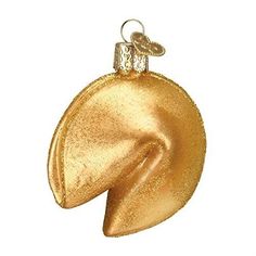 a gold ornament hanging on a white background