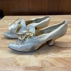 "Antique 1911 Belle Epoque white kid skin heels. Worn by their original owner for their wedding, they have been stored until now. Shoes feature floral beading on the tips, ribbon ties, and a lip. Blemishes include general wear and discoloration, the inserts needing to be re-attached, and the right heel sits off center. The beading is amazingly intact. For the age of the shoe, they are in good/fair condition. Shoes approximately measure 9\" in length and 2.75\" in width at the platform. Please let me know if you have any questions." Vintage Low Heel Wedding Shoes For Party, Vintage Round Toe Wedding Shoes For Party, Vintage White Heels For Wedding, Vintage Heels With Pointed Toe For Wedding, Vintage Pointed Toe Heels For Wedding, Vintage Round Toe Heels For Wedding, Vintage Wedding Heels With Pointed Toe, Vintage Wedding Heels With Round Toe, Vintage High Heel Wedding Shoes For Formal Occasions