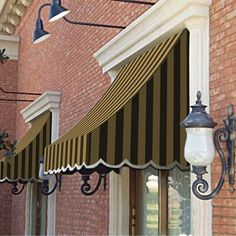 a black and white awning on the side of a building next to a street light