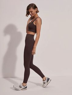 Buttery soft with light compression and minimal seams, our FreeSoft™️ high-rise leggings feature a rolled waistband and tapered inseam panel for optimal comfort. Move freely with four-way stretch and stay cool and dry all day thanks to moisture-wicking properties. Perfect for everyday wear, these versatile leggings with elevate any outfit. Details + Fit Studio model is 5'10", with a 33" bust, 25" waist, 37" hips, and wears a size small. Fabric: 75% Polyester 25% Elastane Care: Machine wash cool Brown Fitted Sporty Activewear, Brown Compressive Activewear For Gym, Brown Fitted Activewear For Yoga, Sporty Brown Activewear For Yoga, Sporty Brown Yoga Activewear, Brown Compression Activewear For Workout, Brown High Stretch Activewear For Pilates, Versatile Brown Yoga Activewear, Brown Seamless Athleisure Activewear