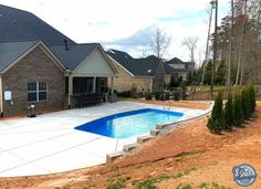 a house with a swimming pool in the front yard