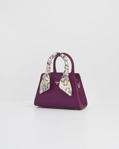 Charming and practical, our Floral Engravings Mini Plum Tote is the perfect accessory. This structured tote, crafted from recycled faux leather, features a twilly scarf and botanical print lining. Its mini size fits all your essentials, while gold-tone hardware and Fable’s signature bee add a touch of elegance.


Key features:


Outer: 100% Polyurethane; Lining: 100% Polyester Scarf: 100% Polyester



Approx. 20 (L) x 13 (H) x 8 (D) cm



Wipe clean with a damp cloth Luxury Christmas Gifts, Twilly Scarf, Polyester Scarf, Twilly, Bottega Veneta Shoulder Bag, Louis Vuitton Shoulder Bag, Mini Tote, Botanical Print, Timeless Treasures