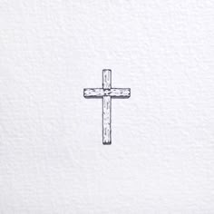 a cross drawn on the side of a white wall